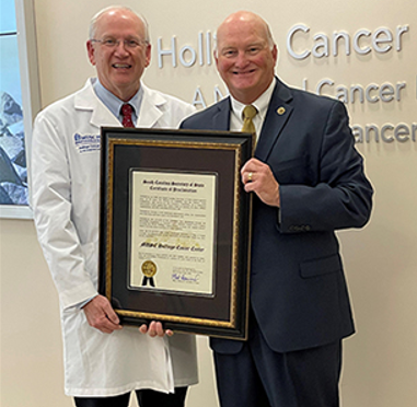 Secretary Hammond presenting MUSC Hollings Cancer Center Director Raymond N. DuBois, M.D., Ph.D., with the Certificate of Proclamation recognizing the award of a $39,024 grant to the MUSC Hollings Cancer Center following a landmark enforcement action against four sham charities and their directors.
